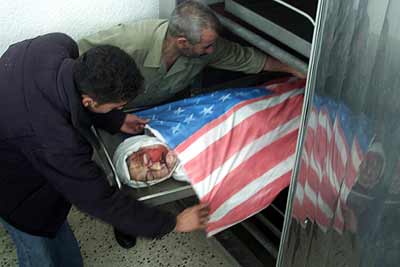 11.The valiant Rachel Corrie is placed in the morgue, covered with the flag of its homeland, the.jpg