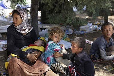 displaced-yazidi-family-waits-food-water-while-resting-iraqi-syrian-border-cros.jpg