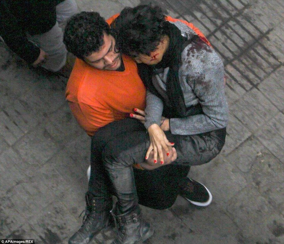 2509A1C900000578-2924709-A_fellow_protester_carries_the_injured_Ms_al_Sabbagh_from_the_sc-a-29_1.jpg