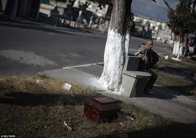 1410788928772_wps_36_a_man_sits_near_a_small_c.jpg