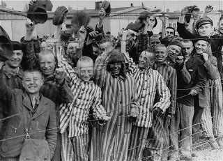 Liberated Dachau camp prisoners cheer U.S. troops.jpg