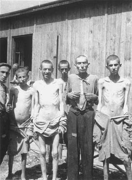 A group of survivors pose in front of a barracks in the newly liberated Ebensee concentration ca.jpg