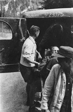 A survivor from Ebensee is loaded onto an ambulance by Austrian personnel for transportation to .jpg