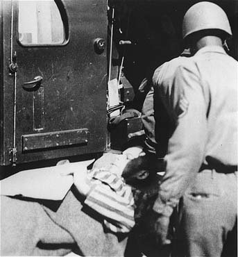 A survivor from the concentration camp at Ebensee is loaded onto an ambulance for transportation.jpg