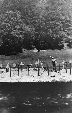 Austrian civilians bury the bodies of former prisoners of the Ebensee concentration camp..jpg