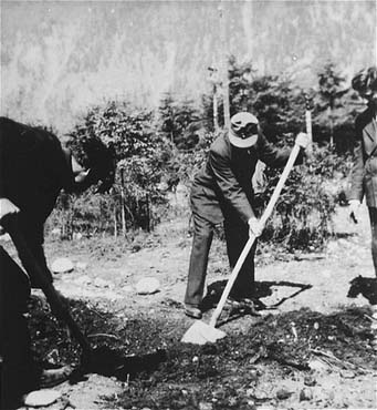 Austrian civilians exhume a mass grave in the Ebensee concentration camp..jpg