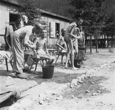 Survivors bathing after liberation, but prior to the installation of a portable shower unit by p.jpg