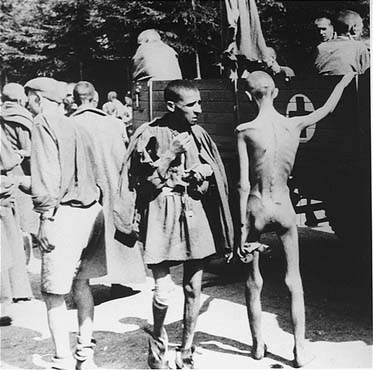 Survivors from Ebensee are loaded onto trucks for transportation to the 139th Evacuation Hospita.jpg