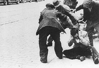 Ukrainian civilians beat a Jew during a pogrom in Lvov.jpg