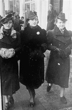 Three young Jewish women walk along a street in Radom.jpg