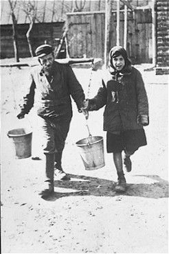 A blind water carrier, aided by his daughter, delivers water to the wealthier Jewish families in.jpg