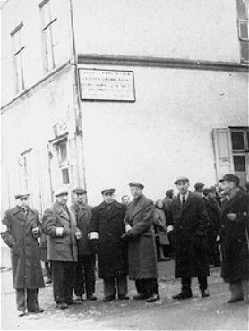 Members of the Jewish council of the Kozienice ghetto stand outside a public kitchen.jpg
