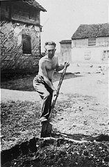 A Jewish man deported from Vienna, Austria, performs forced labor in the Opole Lubelskie ghetto.jpg