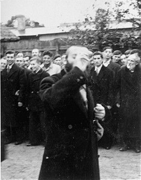 A religious Jew is publicly humiliated in the town square of Raciaz.jpg