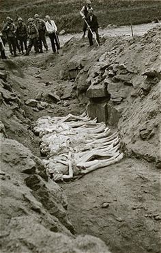 Austrian civilians bury former inmates in a mass grave in the Mauthausen concentration camp.jpg