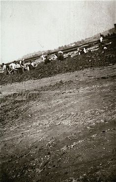 Austrian civilians dig a mass grave to bury the victims of the Mauthausen concentration camp.jpg