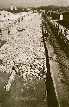 Forced laborers work on the stone foundation of the roll call area in Mauthausen.jpg