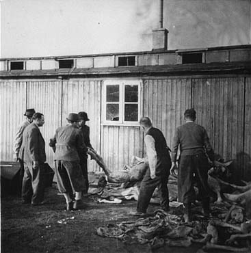 On orders from the U.S. Army, Austrian citizens remove corpses from the 'Russian camp' section.jpg