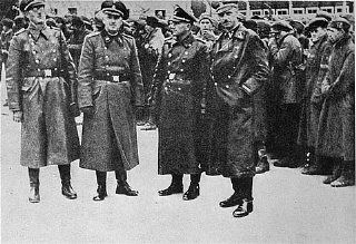 SS officers posing in front of a newly arrived transport of Soviet prisoners of war.jpg