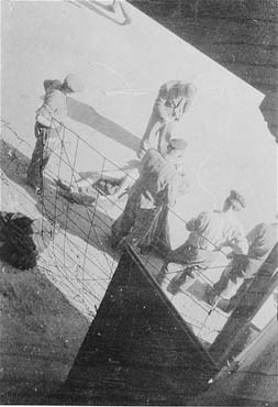 Survivors remove a corpse in Mauthausen after liberation.jpg