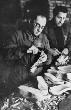 Jewish forced laborers at work making shoes in a ghetto workshop.jpg