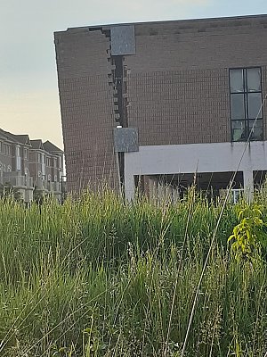 plywood-repaired-building-wall.jpg