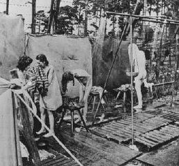 Bergen-Belsen Liberation, April 15, 1945, and Postwar Displaced Persons Camp - Soon after liberation, camp survivors bathe in outdoor showers set up by the British Bergen Bel