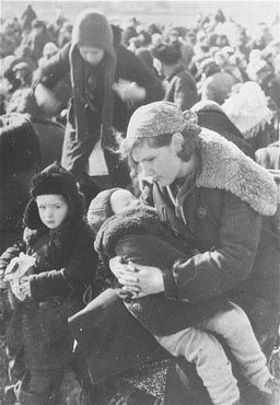 Close-up of a young mother with her two children who have been.jpg