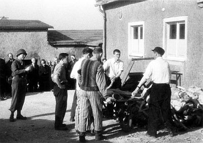 german-civilians-look-survivors-watch-two-men-move-corpses.jpg