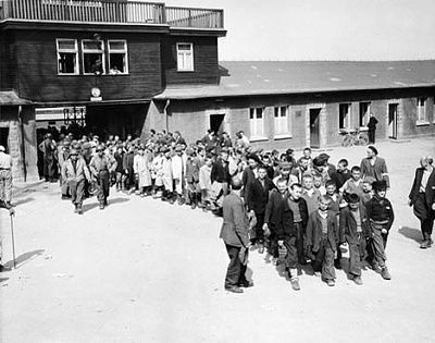 liberated-orphans-march-out-main-gate-buchenwald-camp.jpg