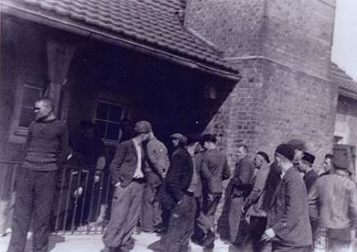 liberated-prisoners-standing-front-buchenwald-crematorium.jpg