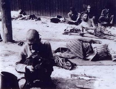 prisoners-relax-outside-barracks-after-liberation.jpg