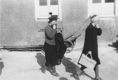 two-german-women-file-past-piles-corpses-outside-crematorium-newly-liberated-buche.jpg
