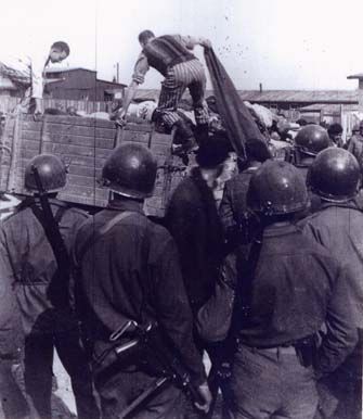 Buchenwald Concentration Camp Liberation Photos Near Weimar, Germany, 1945 - US soldiers view a corpse wagon at Buchenwald
