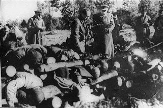 Soviet officials view stacked corpses of victims at the Klooga camp..jpg