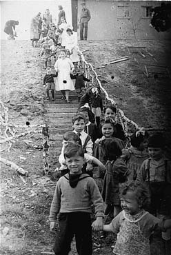 Jewish preschoolers walk down a flight of stairs at the Bergen-Belsen displaced persons camp.jpg