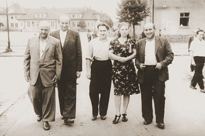 moishe-broda-walks-along-street-group-friends-bergen-belsen-displaced-persons.jpg