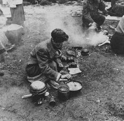 Bergen-Belsen Liberation, April 15, 1945, and Postwar Displaced Persons Camp - Soon after liberation, camp survivors cook in a field