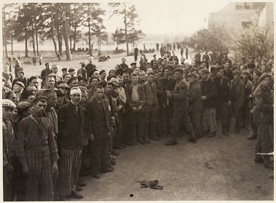 survivors-stand-outside-bergen-belsen-concentration-camp-while-british-soldiers-walk-.jpg