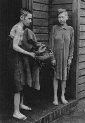 Bergen-Belsen Liberation, April 15, 1945, and Postwar Displaced Persons Camp - Two survivors in front of the women's barracks in the Bergen Belsen concentration camp