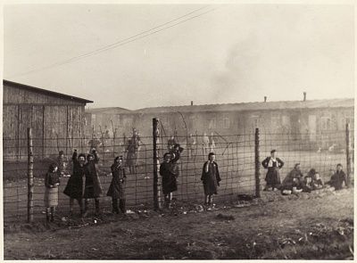 women-survivors-bergen-belsen-concentration-camp-stand-sit-behind-fence-ca.jpg