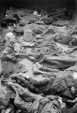 Corpses lie in one of the open railcars of the Dachau death train.jpg