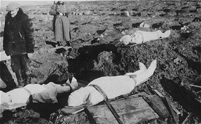 german-soldier-stands-guard-bodies-prepared-burial-jewish-cemetery-kutno.jpg