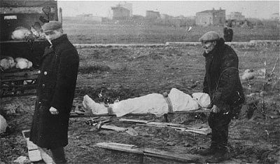two-men-remove-corpse-truck-carry-burial-site-jewish-cemetery-kut.jpg