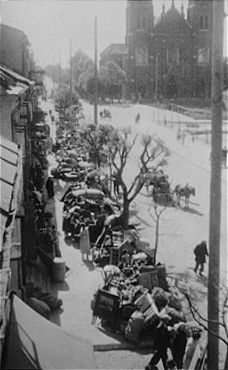 Olkusz, Kutno, Wisznice, Raciąż and Other Jewish Ghettos, 1939-1942 - View of a street in Kutno lined with the belongings of Jews who are being transferred to the ghe