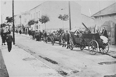 procession-horse-drawn-wagons-bearing-belongings-local-jews.jpg