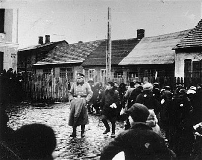 german-police-officer-stands-fenced-yard-among-group-jews-who-have-been-rounded-.jpg
