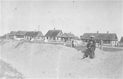 jewish-man-holding-baby-sits-side-ditch-outside-wisznice-ghetto.jpg