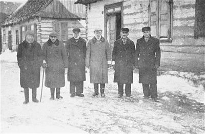 six-members-local-jewish-council-pose-snow-covered-street-wisznice-ghetto.jpg