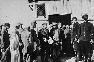 two-camp-guards-supervise-group-jewish-forced-laborers-lining-up-food.jpg